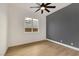Bright bedroom features a modern ceiling fan, wood-look floors, and large window at 2921 Guillemot Ave, North Las Vegas, NV 89084