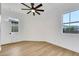 Bright bedroom with lots of natural light, ceiling fan, and wood-look floors at 2921 Guillemot Ave, North Las Vegas, NV 89084