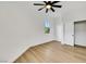 Bright bedroom with wood-look floors, ceiling fan, and sliding closet at 2921 Guillemot Ave, North Las Vegas, NV 89084
