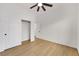 Bright bedroom with wood-look floors, ceiling fan, and sliding door closet at 2921 Guillemot Ave, North Las Vegas, NV 89084