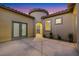 Charming courtyard with decorative pavers, stucco walls, and an arched entryway with beautiful sky at 2921 Guillemot Ave, North Las Vegas, NV 89084