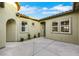 Exterior view of a charming courtyard with stucco walls, decorative pavers, and desert landscaping at 2921 Guillemot Ave, North Las Vegas, NV 89084