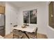 Bright dining area featuring a marble table and view of the outside through a large window at 2921 Guillemot Ave, North Las Vegas, NV 89084