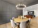 Modern dining room features paneled walls, wood table with seating, and chandelier lighting at 2921 Guillemot Ave, North Las Vegas, NV 89084