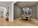 Dining room with designer lighting, gray accent wall, and wood table with seating for six at 2921 Guillemot Ave, North Las Vegas, NV 89084