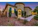 Inviting home exterior featuring a stone walkway, mature landscaping, and a decorative entryway at 2921 Guillemot Ave, North Las Vegas, NV 89084