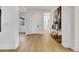 Bright foyer with light wood floors, white walls, console table, and view to another room at 2921 Guillemot Ave, North Las Vegas, NV 89084