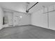 Clean two-car garage featuring an epoxy floor and a water heater at 2921 Guillemot Ave, North Las Vegas, NV 89084