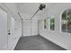 Two car garage with an epoxy floor, arched windows, and a side entry door at 2921 Guillemot Ave, North Las Vegas, NV 89084
