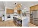 Bright, modern kitchen with stainless steel appliances, island seating, and stylish pendant lighting at 2921 Guillemot Ave, North Las Vegas, NV 89084