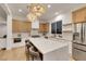 Bright, open kitchen features a large island, stainless steel appliances, and modern lighting at 2921 Guillemot Ave, North Las Vegas, NV 89084