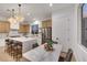 Bright kitchen with large island with seating adjacent to dining area and stainless steel appliances at 2921 Guillemot Ave, North Las Vegas, NV 89084