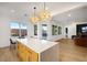 Eat-in kitchen features a large island that flows into the bright living spaces at 2921 Guillemot Ave, North Las Vegas, NV 89084