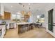 Modern kitchen features stainless appliances, island with seating, and adjacent dining area at 2921 Guillemot Ave, North Las Vegas, NV 89084
