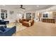 Open concept living room flows into the kitchen and dining area with wood floors and stylish decor at 2921 Guillemot Ave, North Las Vegas, NV 89084
