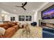 Bright living room featuring a comfortable sectional sofa, contemporary fireplace, and large windows at 2921 Guillemot Ave, North Las Vegas, NV 89084