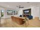 Bright living room with modern fireplace, TV, seating, and large windows for natural light at 2921 Guillemot Ave, North Las Vegas, NV 89084