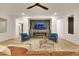 Comfortable living room with fireplace, seating, decorative rug and light-filled spacious design at 2921 Guillemot Ave, North Las Vegas, NV 89084