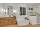 Spacious bathroom with dual vanities, a modern soaking tub, and a glass-enclosed shower at 2921 Guillemot Ave, North Las Vegas, NV 89084