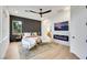 Modern bedroom with stylish decor, a ceiling fan, and an electric fireplace with a mounted television at 2921 Guillemot Ave, North Las Vegas, NV 89084