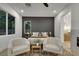 Modern bedroom with stylish decor, a comfortable seating area and a glimpse into the bathroom at 2921 Guillemot Ave, North Las Vegas, NV 89084