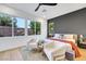 Modern bedroom with stylish decor, comfortable seating area and many large windows at 2921 Guillemot Ave, North Las Vegas, NV 89084