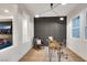 Bright office space featuring a modern desk, chair, and large windows with an accent wall at 2921 Guillemot Ave, North Las Vegas, NV 89084