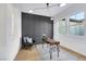 Bright office space featuring a modern desk, accent wall, and large windows for natural light at 2921 Guillemot Ave, North Las Vegas, NV 89084