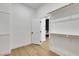 A walk-in closet featuring an open doorway and wood shelving on white walls at 2921 Guillemot Ave, North Las Vegas, NV 89084