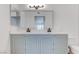 Bathroom featuring a dual sink vanity, large mirror, updated fixtures, and plenty of storage space at 3103 Key Largo Dr # 103, Las Vegas, NV 89120