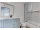 Updated bathroom with a sleek glass shower, white tile, modern fixtures, and a light blue vanity at 3103 Key Largo Dr # 103, Las Vegas, NV 89120