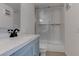Updated bathroom with a sleek glass shower, white tile, and modern fixtures and finishes at 3103 Key Largo Dr # 103, Las Vegas, NV 89120