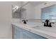 Spacious bathroom featuring dual sinks, modern fixtures, large mirrors, and white countertops at 3103 Key Largo Dr # 103, Las Vegas, NV 89120