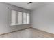 Bright bedroom with wood-look floors, white walls, and a window with vertical blinds at 3103 Key Largo Dr # 103, Las Vegas, NV 89120