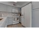 Beautiful kitchen featuring neutral cabinets, white appliances, and unique backsplash at 3103 Key Largo Dr # 103, Las Vegas, NV 89120
