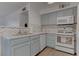 Updated kitchen with neutral cabinets, sleek countertops, and chevron backsplash at 3103 Key Largo Dr # 103, Las Vegas, NV 89120