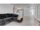 Open-concept living room featuring new gray laminate flooring and a view of the kitchen at 3103 Key Largo Dr # 103, Las Vegas, NV 89120
