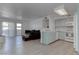 Open-concept living area with kitchen, comfortable seating, and sliding glass doors to the outside at 3103 Key Largo Dr # 103, Las Vegas, NV 89120