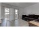 Well-lit living room with a dark sofa, a sliding glass door and light laminate floors at 3103 Key Largo Dr # 103, Las Vegas, NV 89120