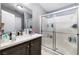 Bright bathroom with shower, sink, and a large mirror at 320 W Van Buren Ave, Las Vegas, NV 89106