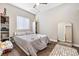 Relaxing bedroom with stylish hardwood floors, large bed and a wall mirror, creating a comfortable retreat at 320 W Van Buren Ave, Las Vegas, NV 89106