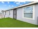 Inviting home with green turf, showcasing the exterior features and a secure entrance at 320 W Van Buren Ave, Las Vegas, NV 89106