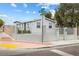 Charming single-story home featuring a secure fenced yard, freshly painted exterior, and manicured landscaping at 320 W Van Buren Ave, Las Vegas, NV 89106