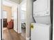 Efficient laundry area featuring a stacked washer and dryer setup next to a bedroom at 320 W Van Buren Ave, Las Vegas, NV 89106