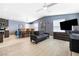 Open concept living space featuring a full-sized sofa, wood-look flooring, and ceiling fan at 320 W Van Buren Ave, Las Vegas, NV 89106