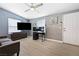 Bright living space features hardwood floors, neutral paint, large TV, and ceiling fan at 320 W Van Buren Ave, Las Vegas, NV 89106