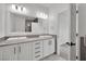 Bathroom featuring double sinks, a large mirror, and white cabinets at 3221 Birdwatcher Ave, North Las Vegas, NV 89084