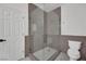 Modern bathroom featuring a glass enclosed shower with gray subway tile and white hexagon tile flooring at 3221 Birdwatcher Ave, North Las Vegas, NV 89084