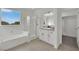 Bathroom featuring a tub, shower, vanity, and walk-in closet at 3221 Birdwatcher Ave, North Las Vegas, NV 89084