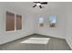 Bright bedroom with a ceiling fan, carpeted floor, and two windows offering great natural light at 3221 Birdwatcher Ave, North Las Vegas, NV 89084